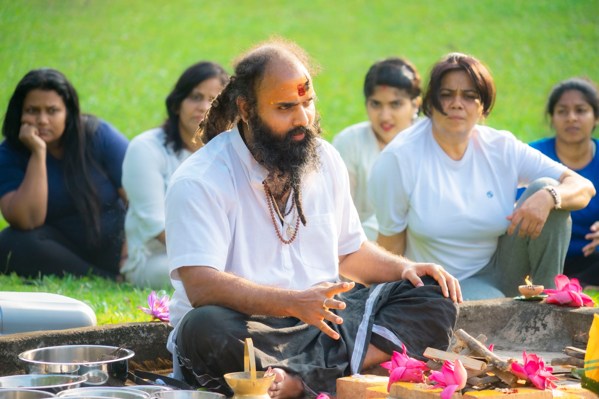 Ceremonial preparations with utensils and flowers for a sacred ritual.